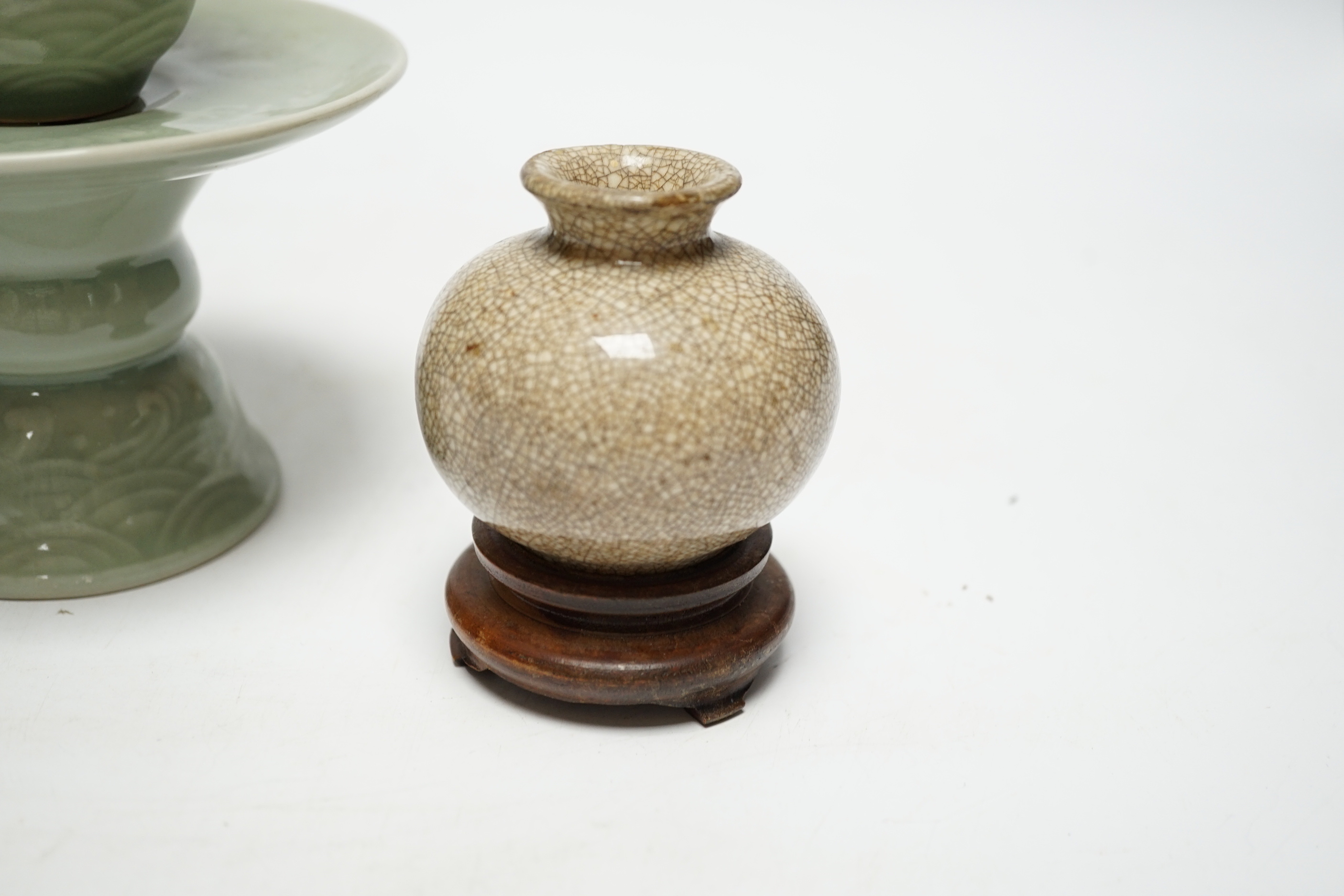 A Chinese celadon glazed 'dragon' puzzle cup and stand, early 20th century and a Chinese crackle glaze vase, 19th century, cup 7.5cm